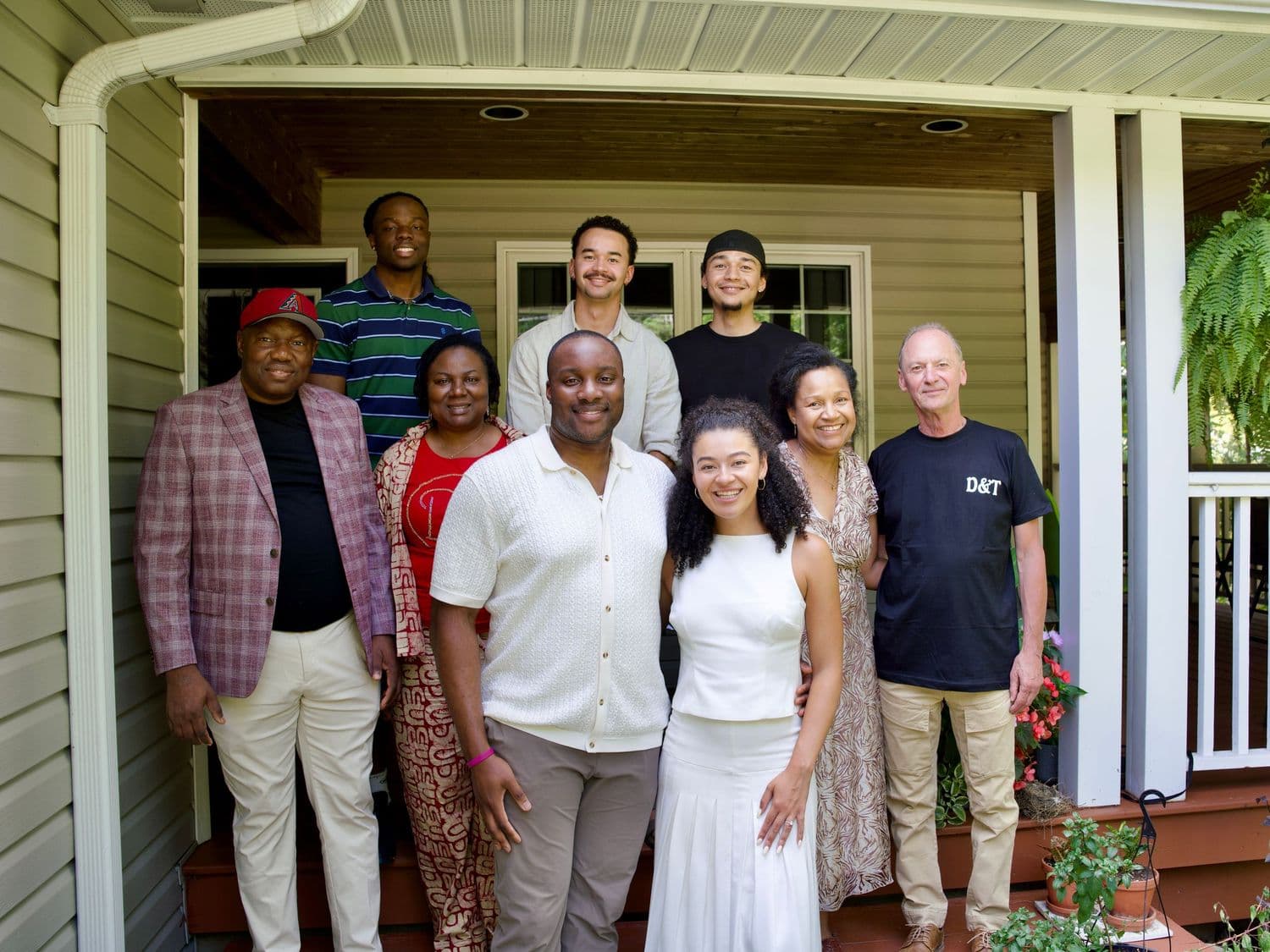 A family group portrait outside on a porch.
