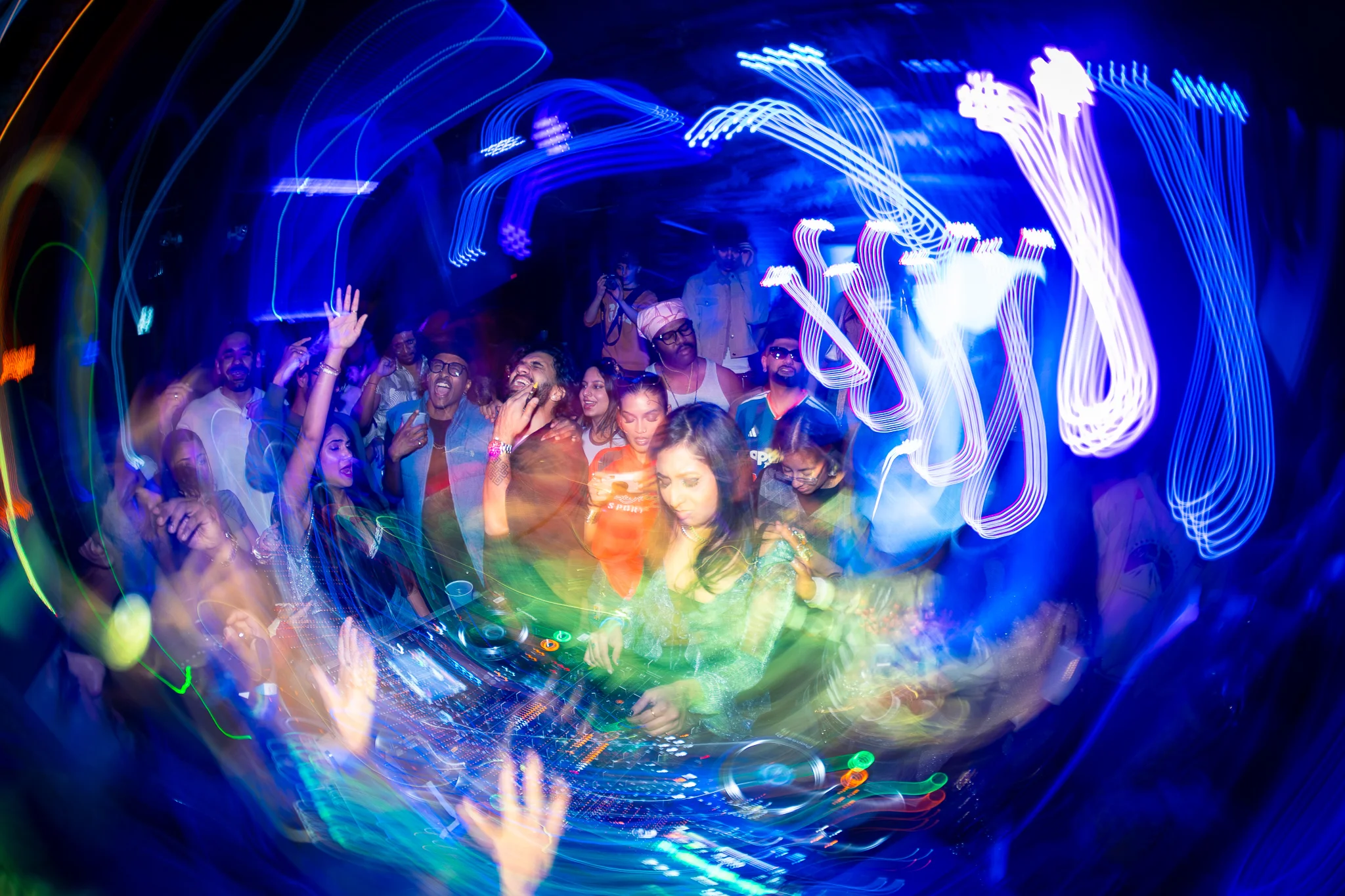 Abstract neon light trails spiral over a packed dance floor at MOOVE Toronto.